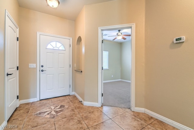 tiled entryway featuring ceiling fan