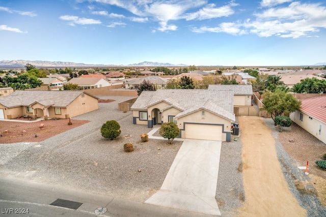 view of front of property with a garage and a mountain view