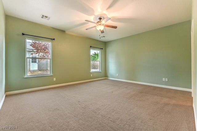 empty room featuring carpet flooring and ceiling fan