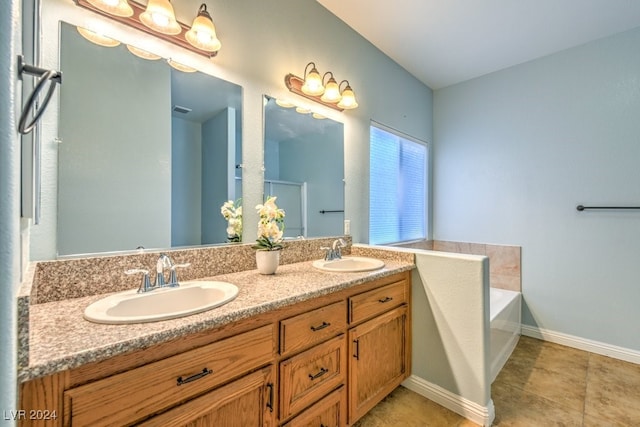 bathroom featuring a bath, tile patterned flooring, and vanity