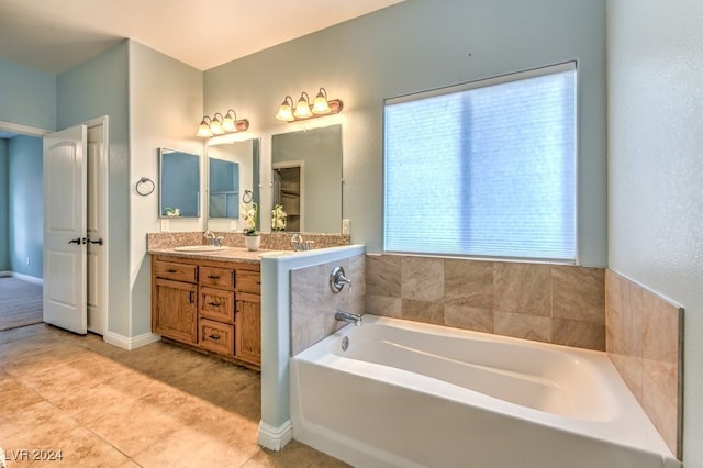 bathroom with vanity, a tub, and tile patterned flooring