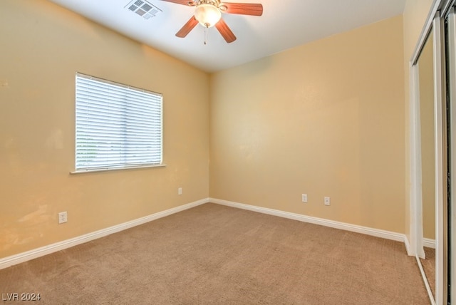 unfurnished bedroom with light colored carpet and ceiling fan