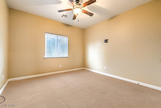 empty room featuring carpet flooring and ceiling fan