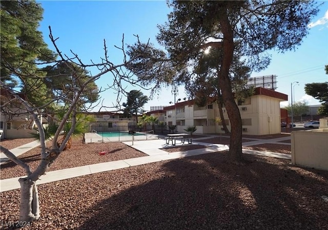 view of yard featuring a fenced in pool and a patio