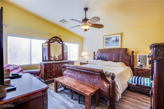 bedroom with lofted ceiling, multiple windows, ceiling fan, and light wood-type flooring