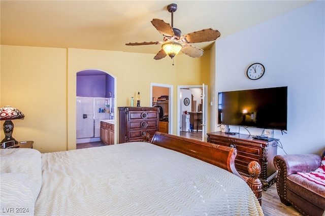 bedroom with ensuite bathroom, a spacious closet, ceiling fan, and a closet