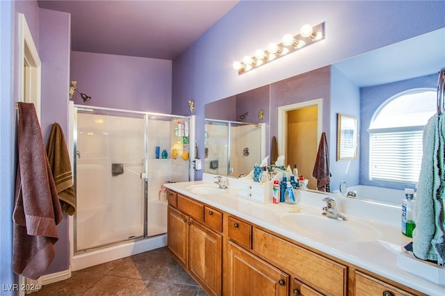 bathroom featuring vanity, tile patterned flooring, and walk in shower