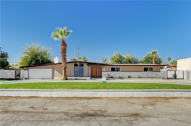 view of front of house with a garage and a front yard