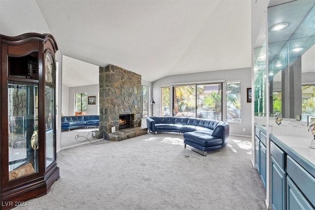 carpeted living room with a fireplace and vaulted ceiling