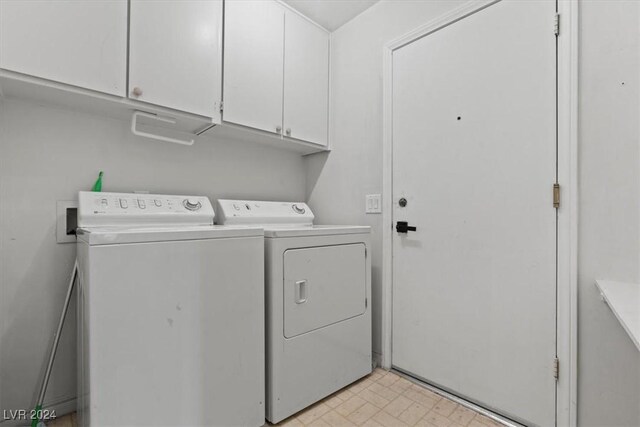 laundry area featuring cabinets and washing machine and dryer