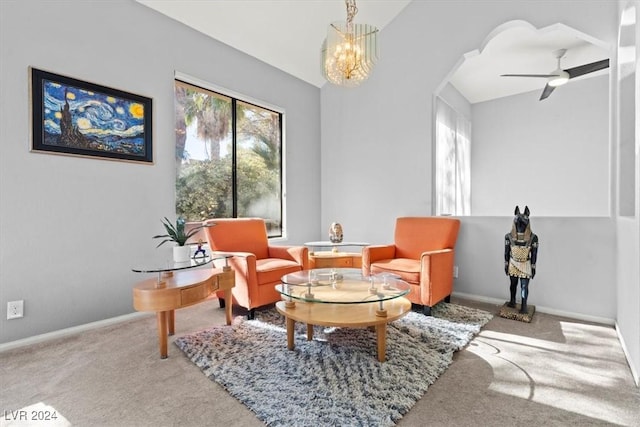 living area with a wealth of natural light, ceiling fan with notable chandelier, and carpet flooring