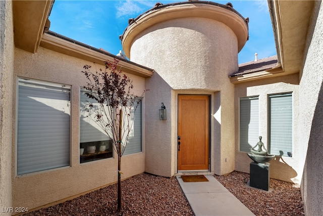 doorway to property with stucco siding