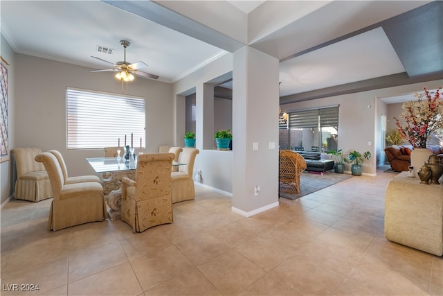 dining room with visible vents, baseboards, ornamental molding, light tile patterned floors, and a ceiling fan