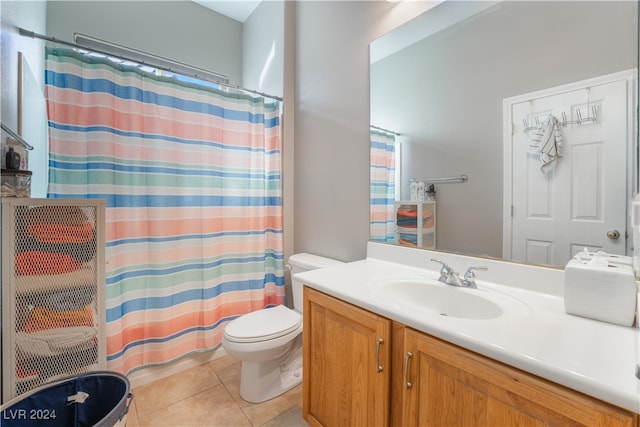 bathroom with tile patterned floors, a shower with curtain, toilet, and vanity