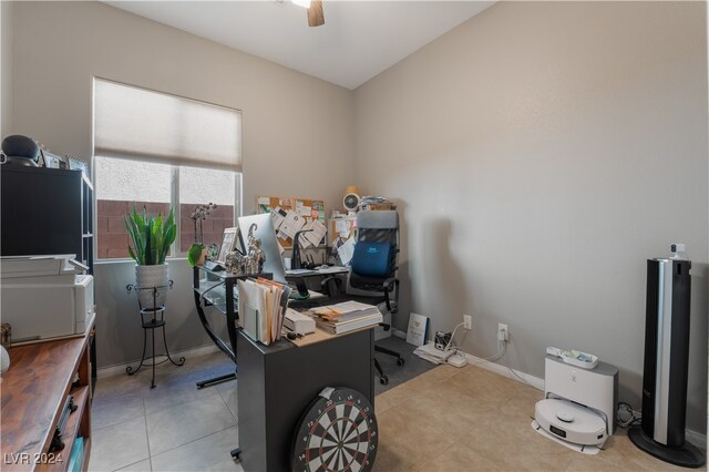 tiled home office featuring a ceiling fan and baseboards