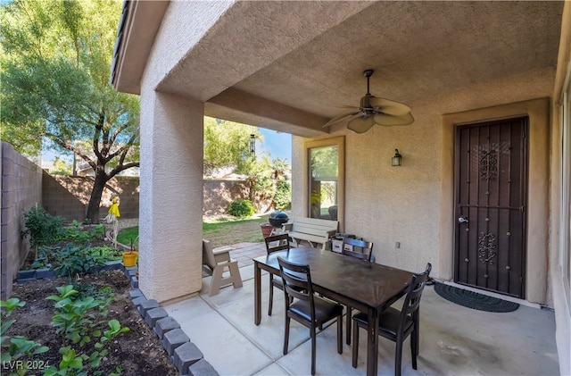 view of patio / terrace featuring outdoor dining area, a fenced backyard, and a ceiling fan