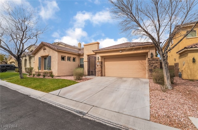 mediterranean / spanish house with stucco siding, concrete driveway, a garage, stone siding, and a tiled roof