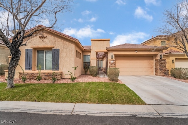 mediterranean / spanish home featuring stone siding, stucco siding, an attached garage, and driveway