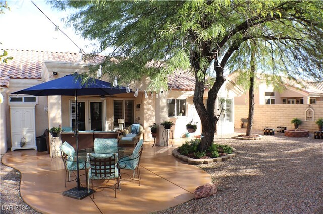 back of property featuring french doors and a patio area