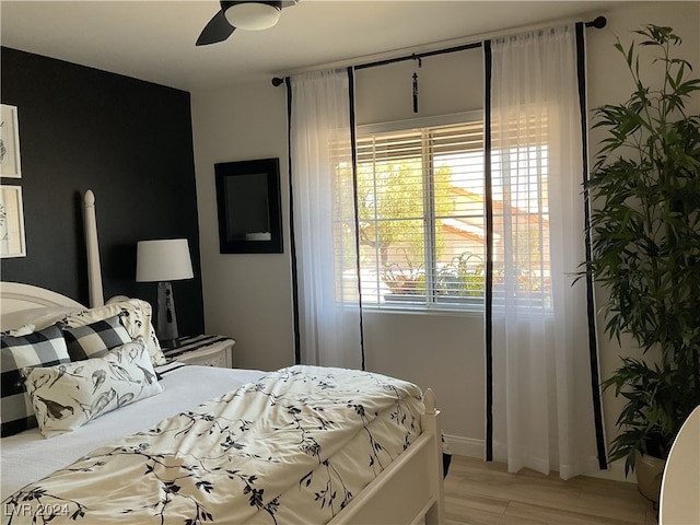 bedroom with ceiling fan and light wood-type flooring