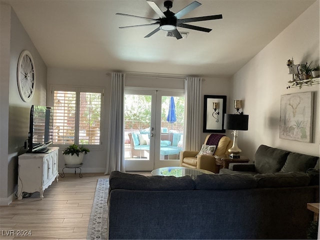 living room featuring light hardwood / wood-style flooring, french doors, ceiling fan, and plenty of natural light