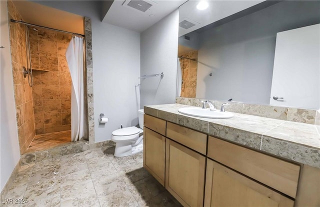 bathroom featuring vanity, toilet, and curtained shower