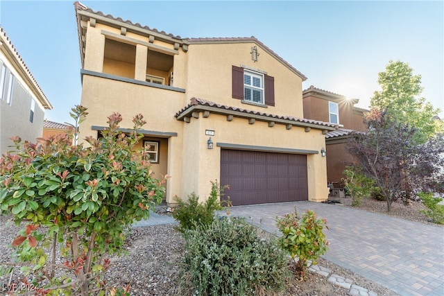 mediterranean / spanish-style house with a garage