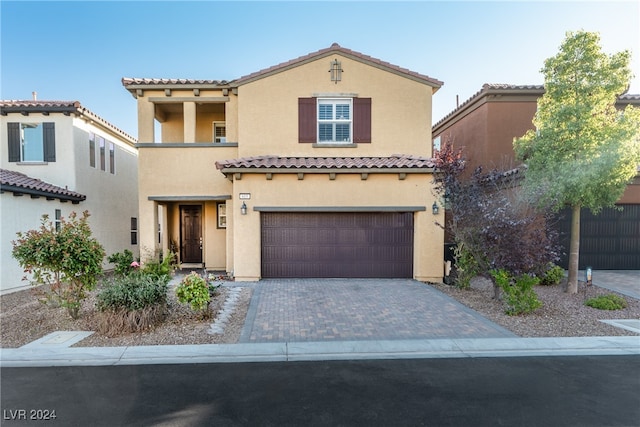 mediterranean / spanish house featuring a garage