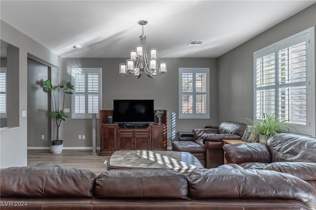 living room featuring wood-type flooring and a notable chandelier