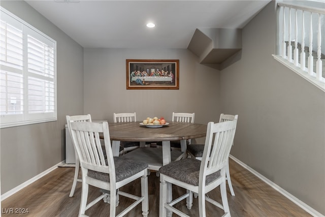 dining area with dark hardwood / wood-style flooring