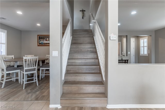 staircase with wood-type flooring