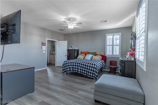 bedroom with ceiling fan and wood-type flooring