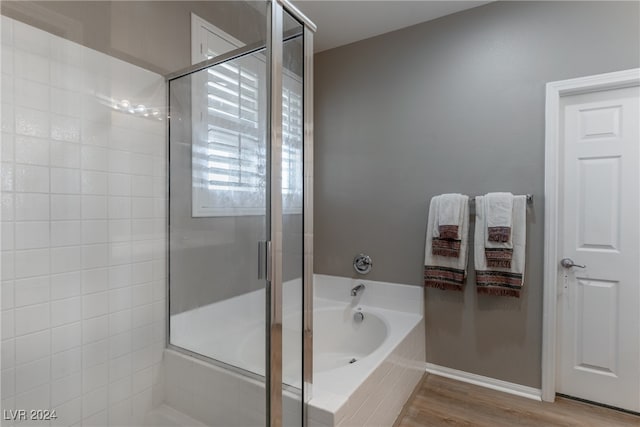 bathroom with hardwood / wood-style floors and plus walk in shower