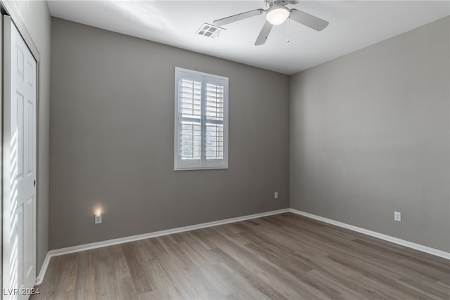 spare room with hardwood / wood-style floors and ceiling fan