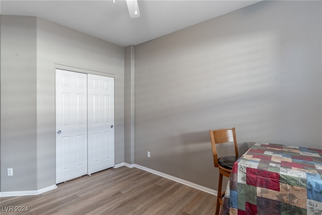 bedroom featuring hardwood / wood-style floors, ceiling fan, and a closet