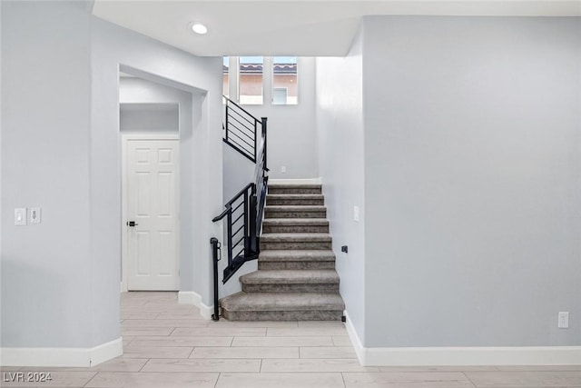 staircase featuring wood-type flooring