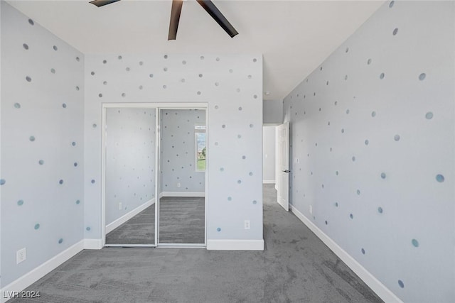 unfurnished bedroom featuring carpet, ceiling fan, and a closet