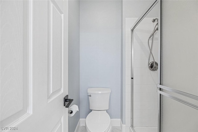 bathroom with an enclosed shower and toilet