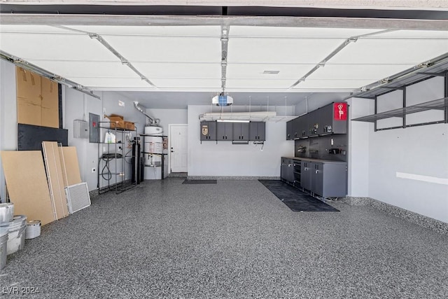 garage featuring electric panel and a garage door opener