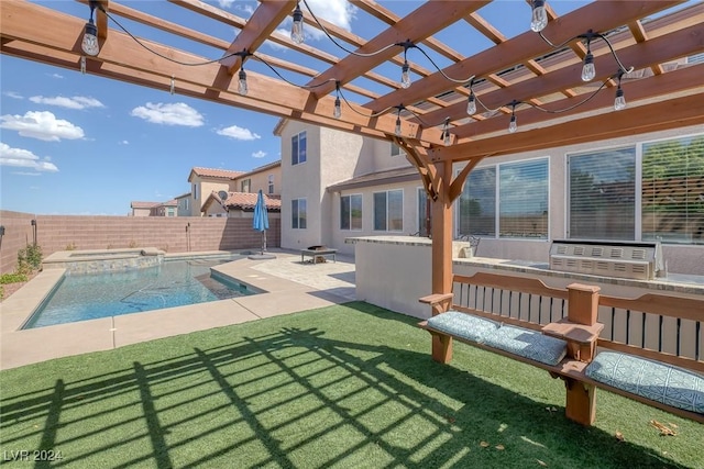 view of swimming pool with a yard, exterior kitchen, an outdoor fire pit, a pergola, and a patio area