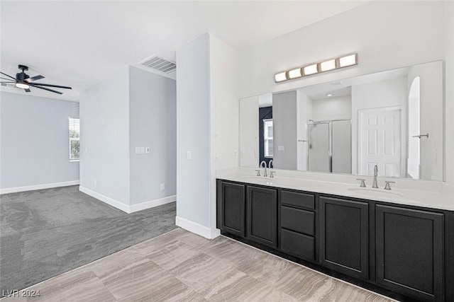 bathroom featuring plenty of natural light, ceiling fan, a shower with door, and vanity