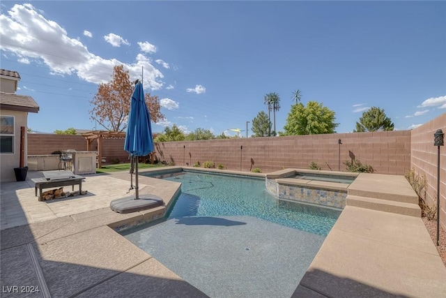 view of pool with an in ground hot tub and a patio