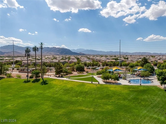 view of community with a mountain view and a yard