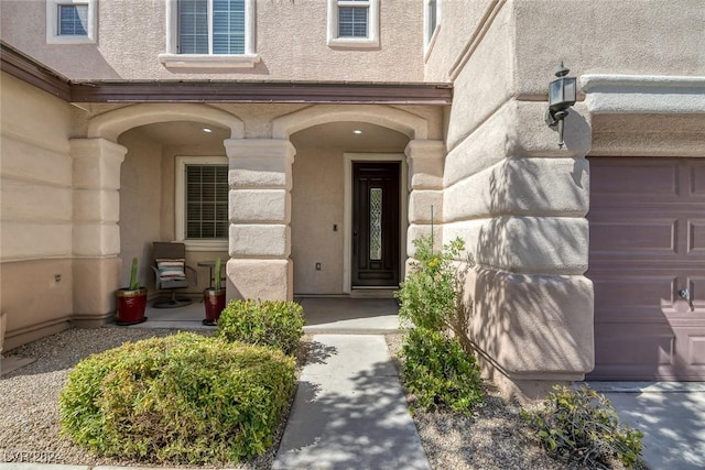 doorway to property with a garage