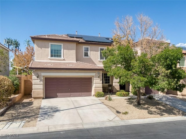 view of front of home with solar panels and a garage