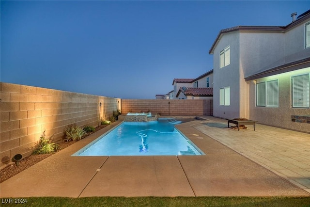 view of swimming pool with a patio area and an in ground hot tub