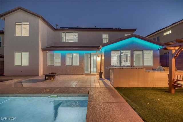 back of house with a yard and a patio