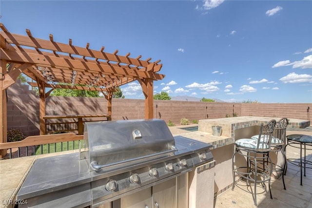 view of patio with a pergola and grilling area