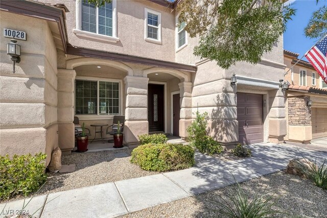 view of exterior entry featuring a garage