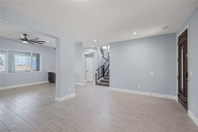 unfurnished living room with ceiling fan and light hardwood / wood-style flooring